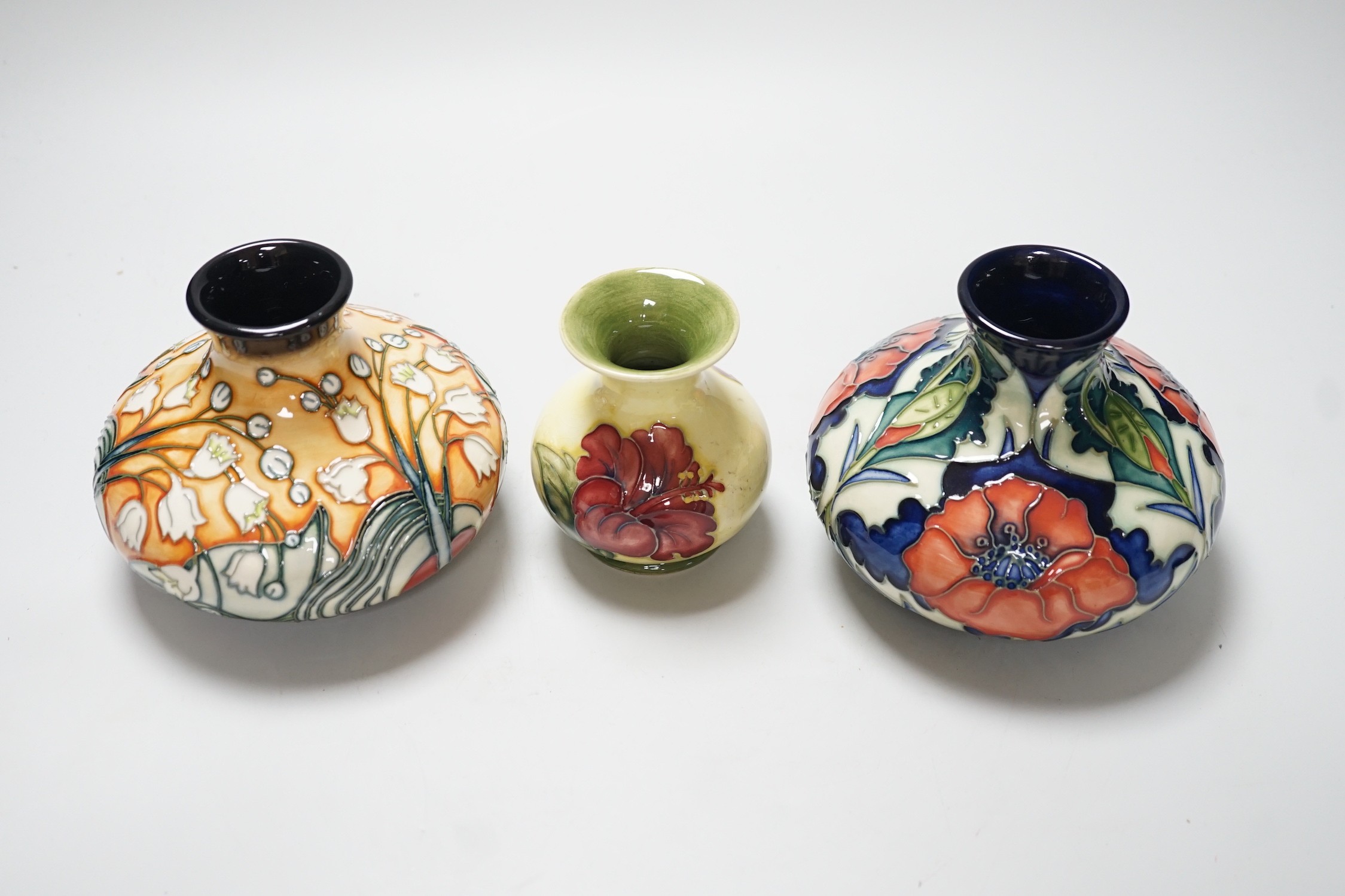 Three Moorcroft vases, in Poppy, Hibiscus and Tulip designs, tallest 10.5 cm, one boxed